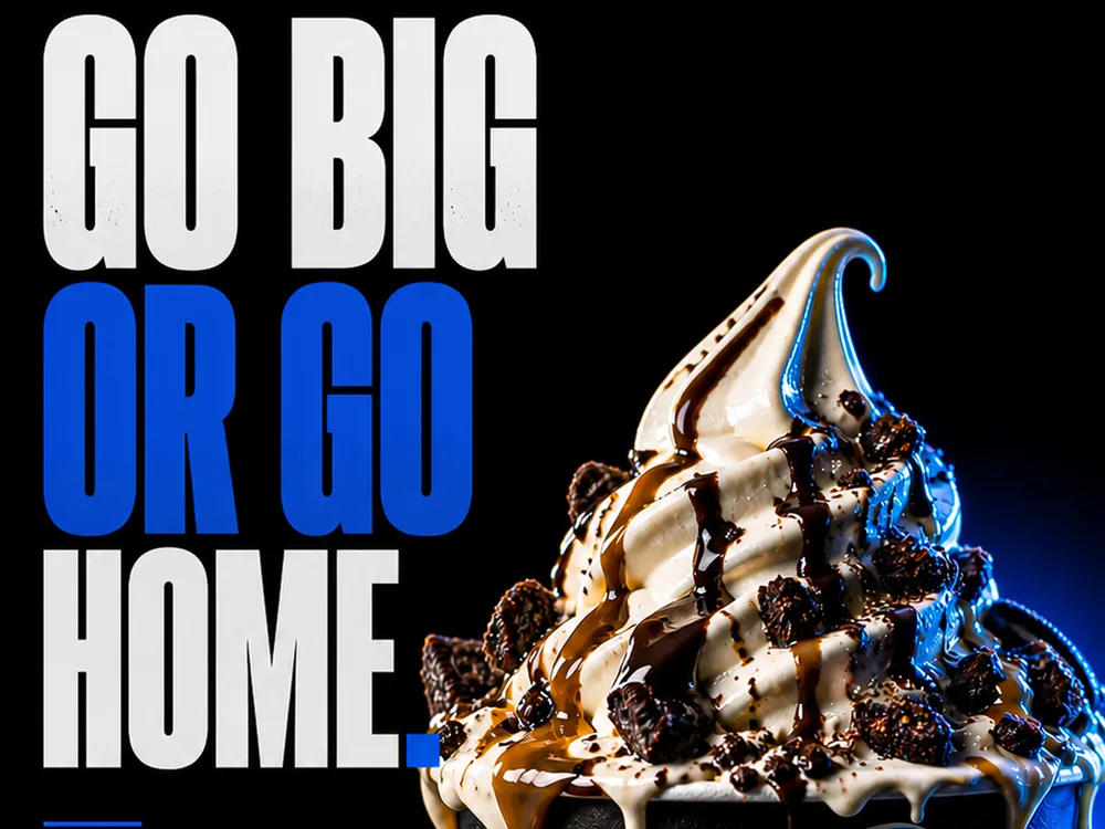 The Big Spoon campaign poster reading Go Big or Go Home beside a loaded soft-serve swirl.